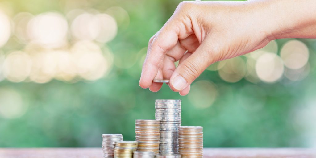 Concept of saving money and investing on out of focus background.